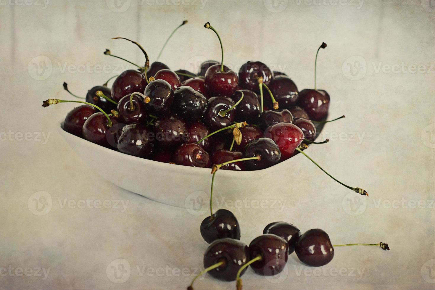 l juicy fresh summer cherries in a white bowl on a vintege background photo