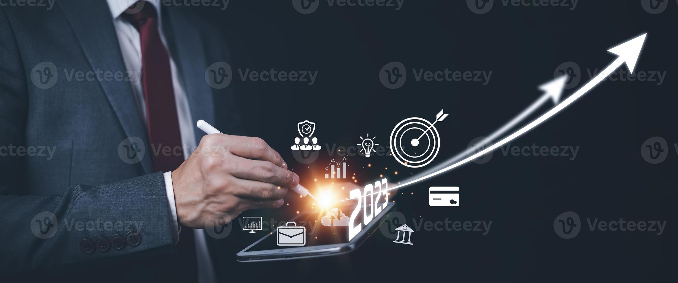 2023 and Startup concept with icon business and network connection on modern virtual interface from digital tablet.Businessman Touching tablet and graph Screen Icon of media screen, Technology Process photo
