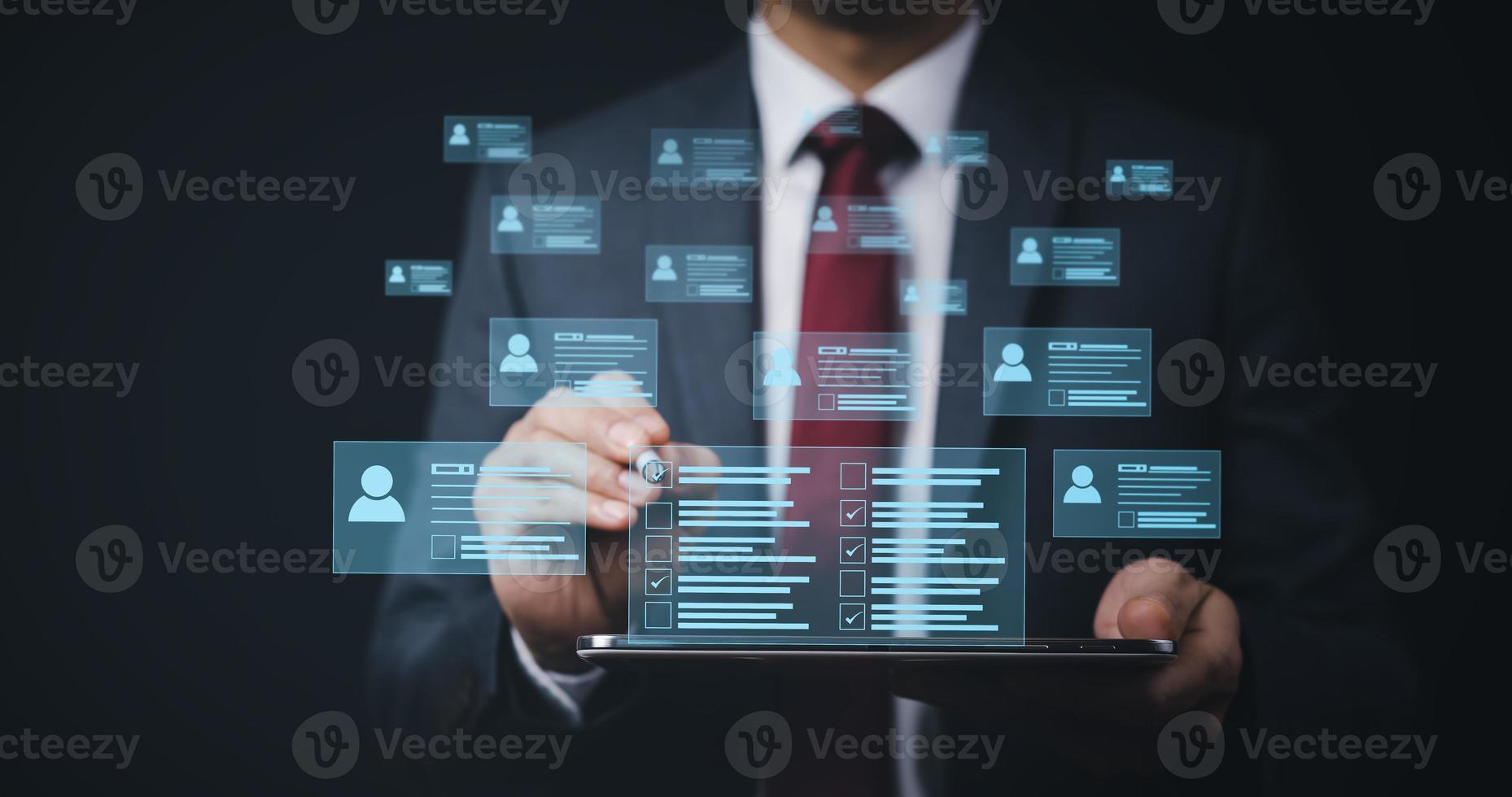 Businessman hand touch Online documentation database, complete the online survey form, answer the test questions. Marked checklist on a clipboard. Human resources and management concept. photo