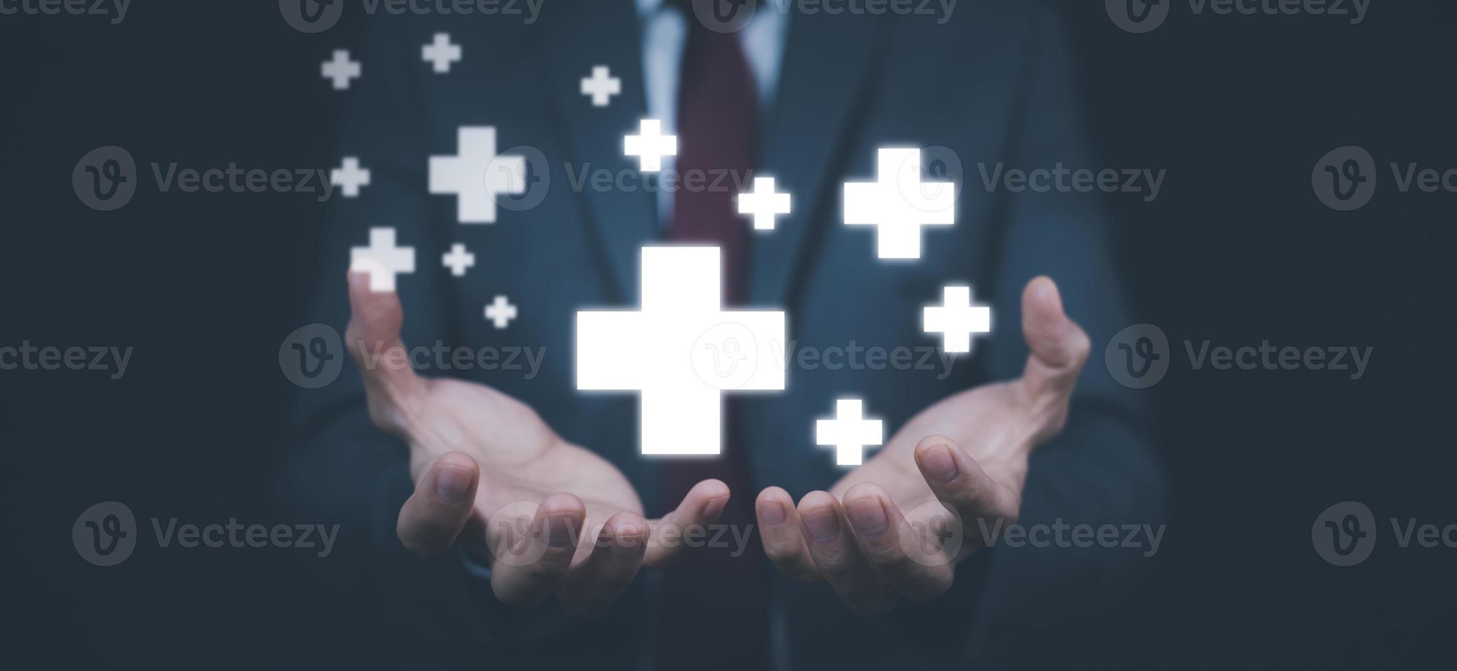 Concept Health care and medical services with technology, Businessman hold in hand offer positive thing such as profit, benefits, development, CSR represented by plus sign, hand shows the plus sign. photo