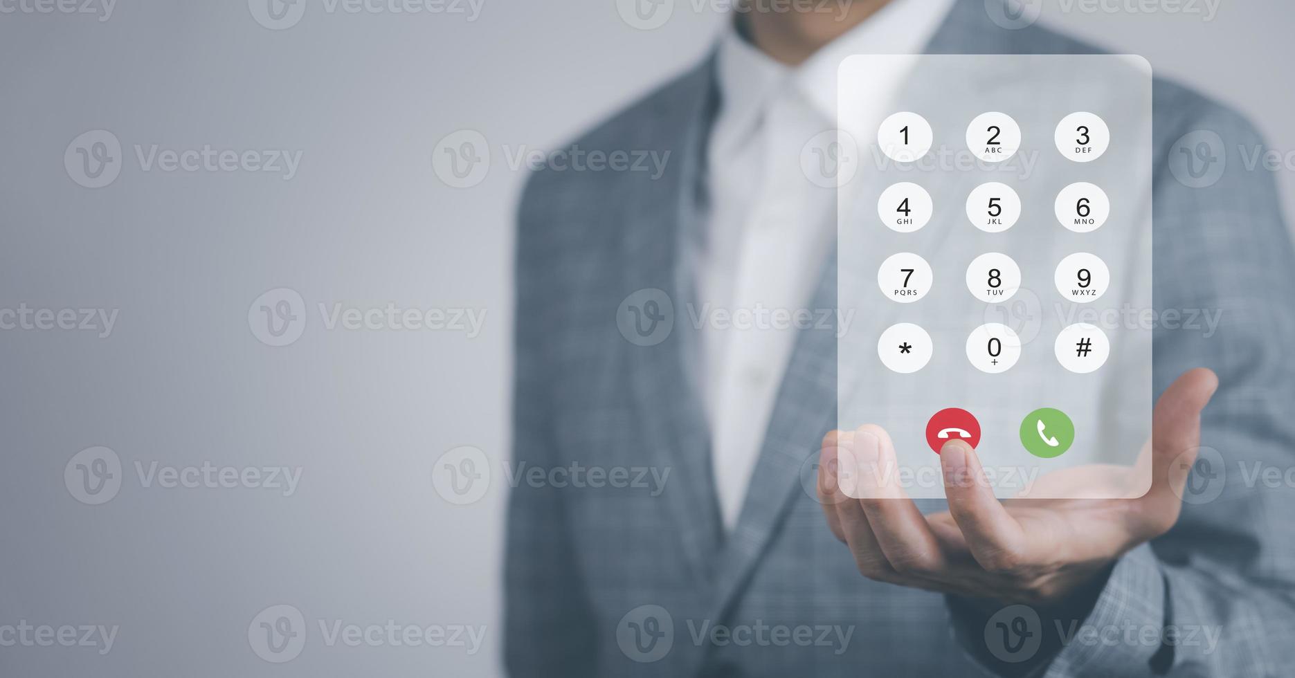 Dialing on virtual telephone keypad with transparent telephone buttons, businessman touch Emergency button of telephone number on screen, Finger touch number on smartphone to make a call, close up, photo