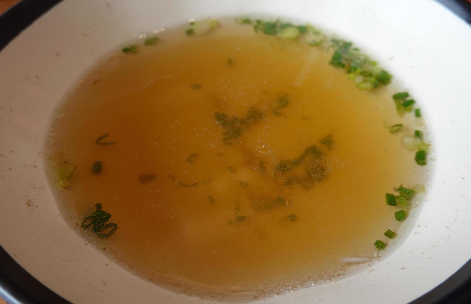 Bone broth made from pork ribs , served in a bowl with parsley photo