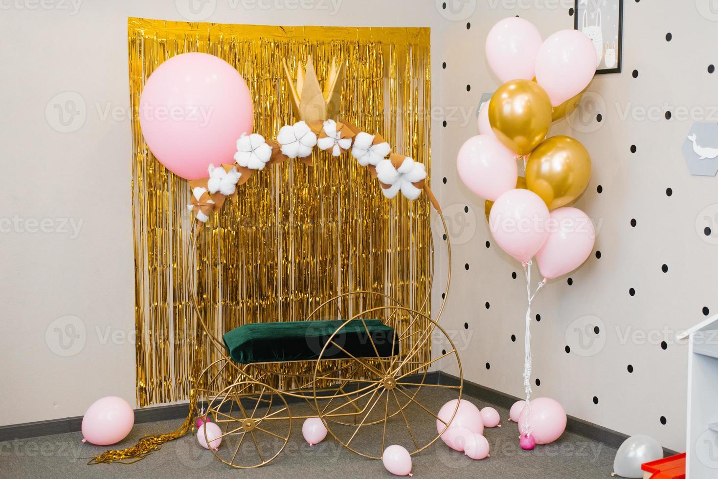 Photo zone for a little Princess, a carriage and balloons on a Golden shiny background. Decor for a child's birthday