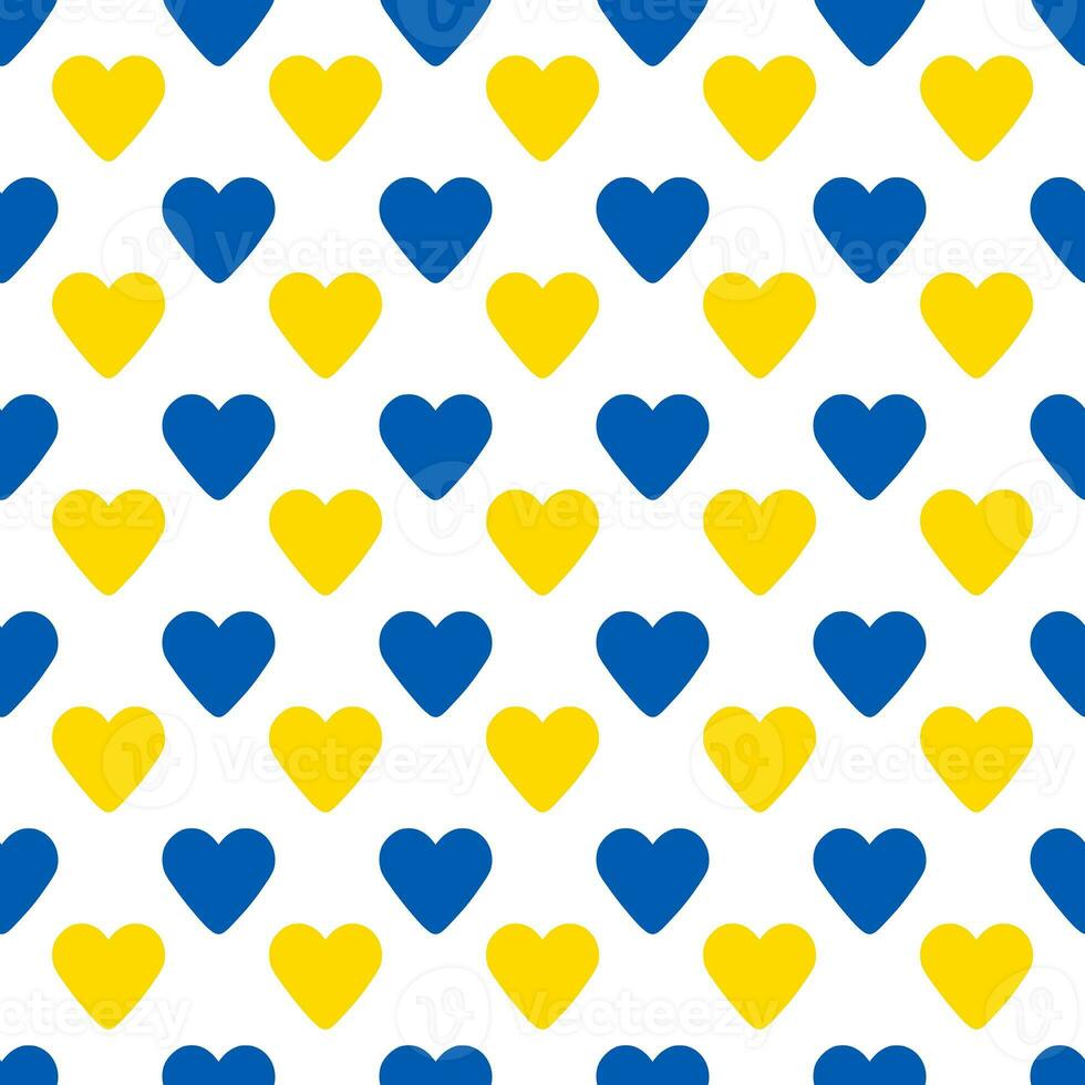 seamless pattern made of blue and yellow hearts over white photo