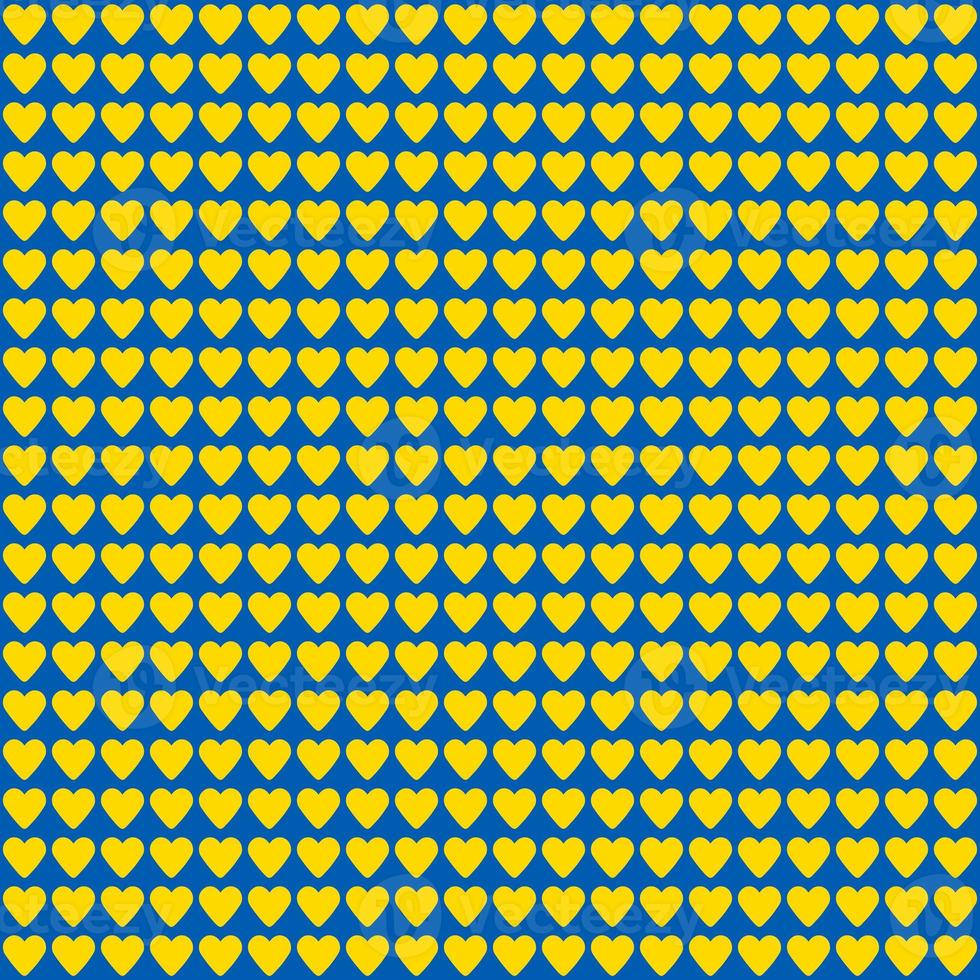 seamless pattern made of yellow hearts on blue background photo