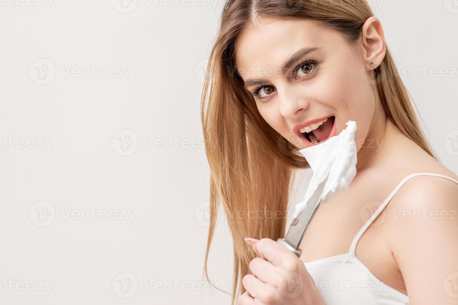 Woman with knife and shaving foam photo