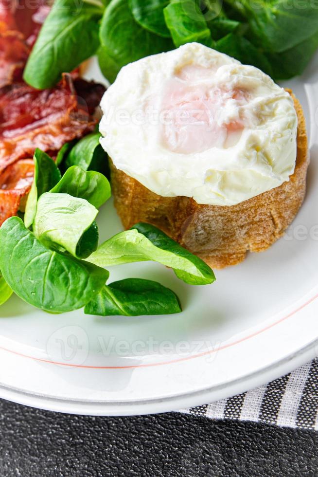 poached egg breakfast bacon, green leaves salad mix meal food snack on the table copy space food background rustic top view photo