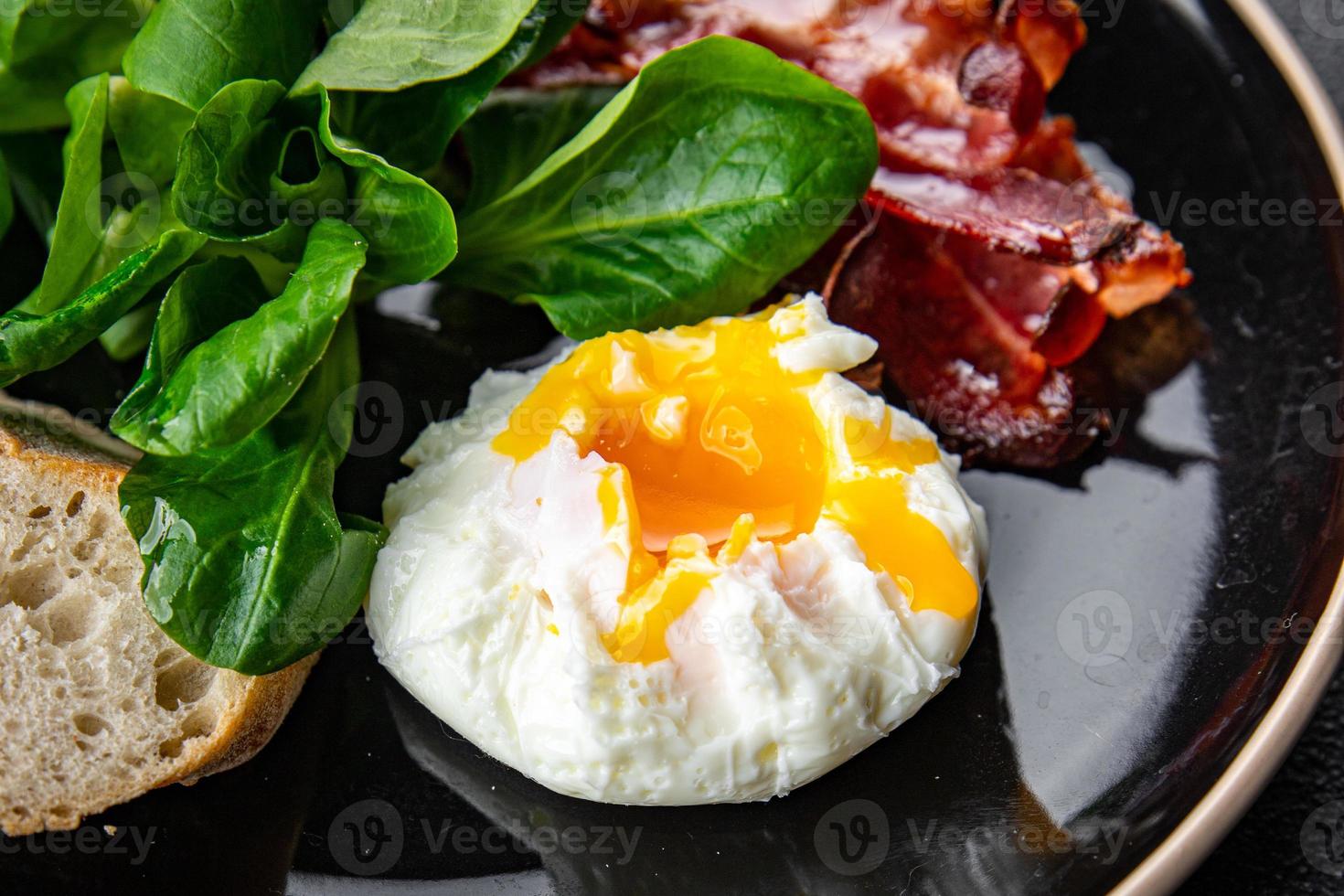 poached egg breakfast bacon, green leaves salad mix meal food snack on the table copy space food background rustic top view photo
