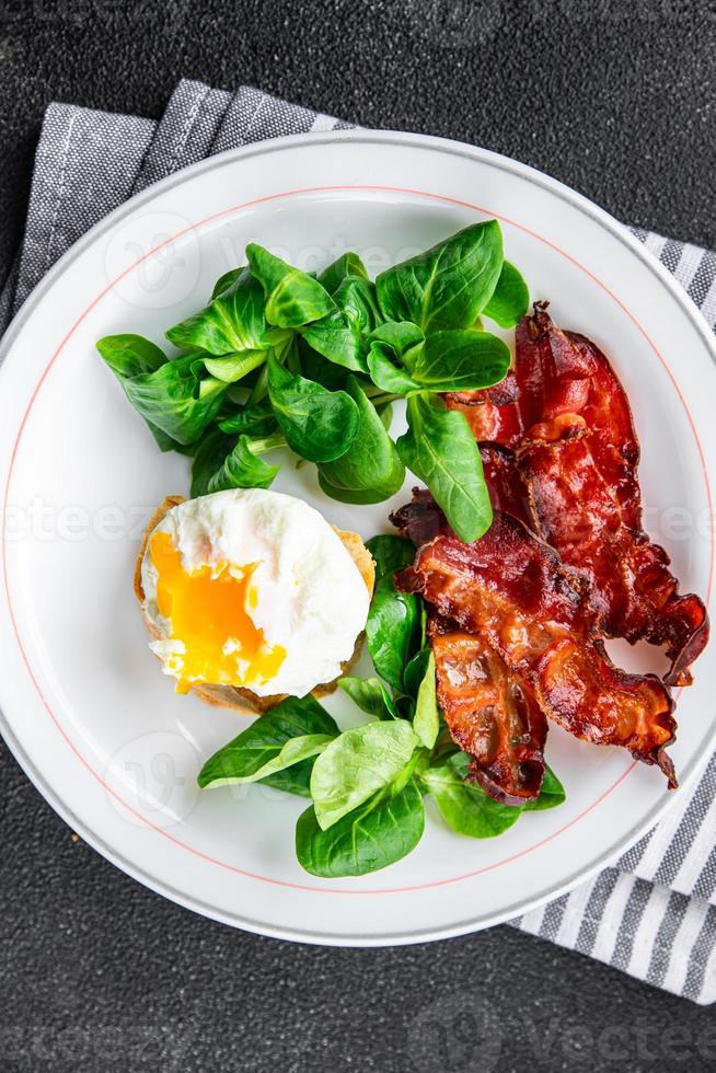 poached egg breakfast bacon, green leaves salad mix meal food snack on the table copy space food background rustic top view photo