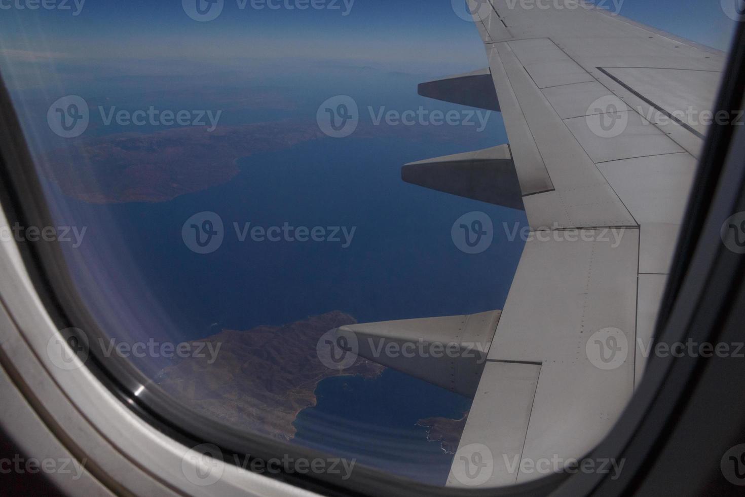 view on Greek islands through window of aircraft photo