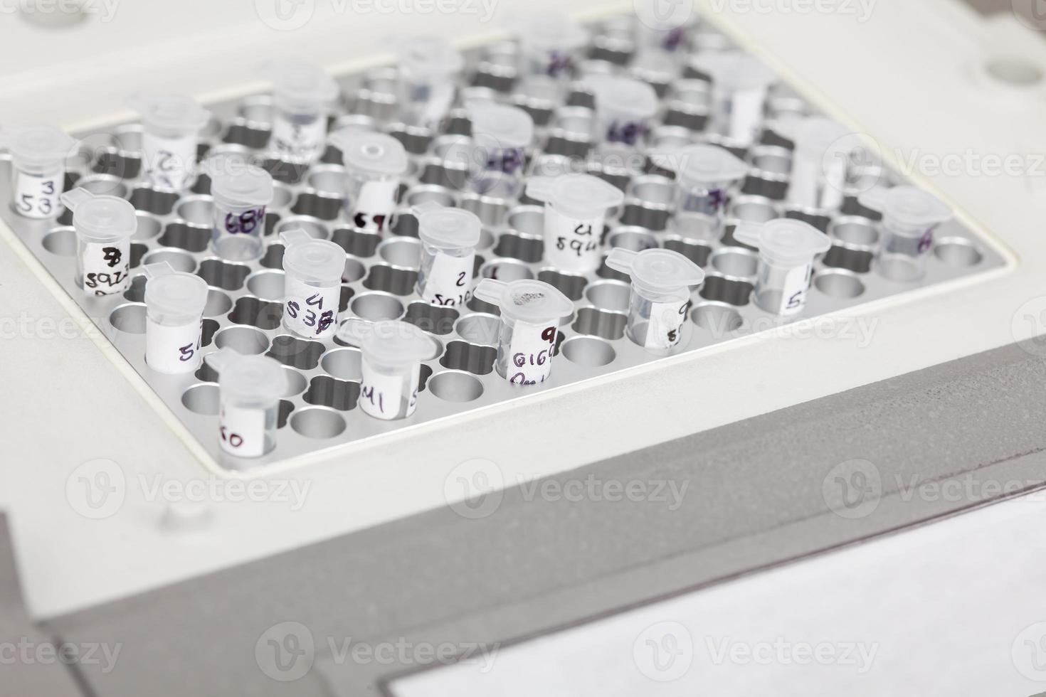 Closeup of test tubes at a thermal cycler block in a molecular biology laboratory. Polymerase chain reaction technique. PCR technique photo