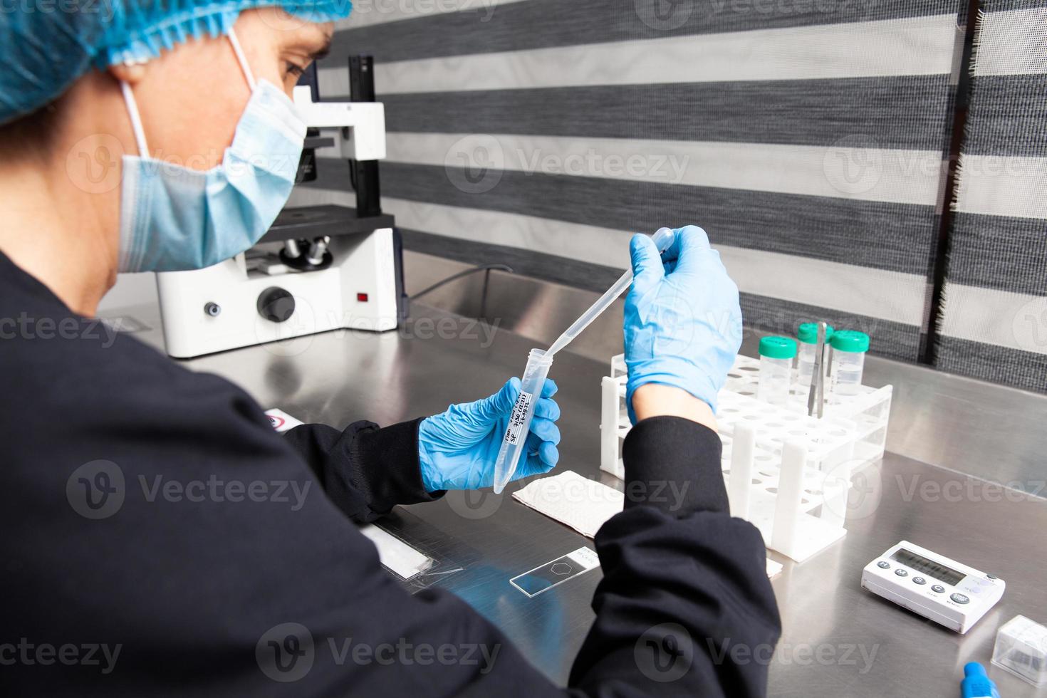 Female scientist preparing slides for karyotipe and fluorescence in situ hybridization - FISH in the laboratory photo