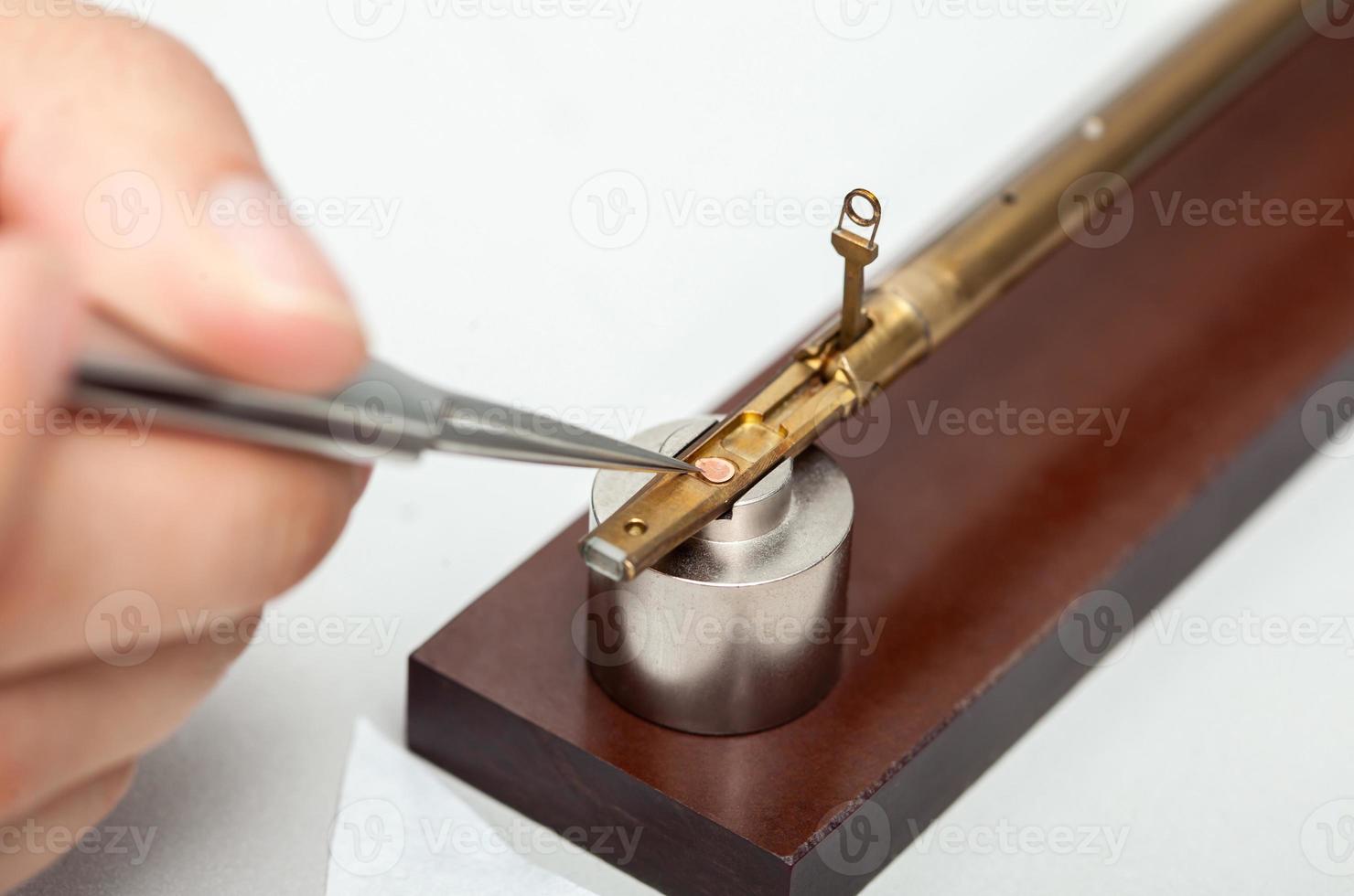 Transmission electron microscope sample holder been loaded with an specimen on a grid photo