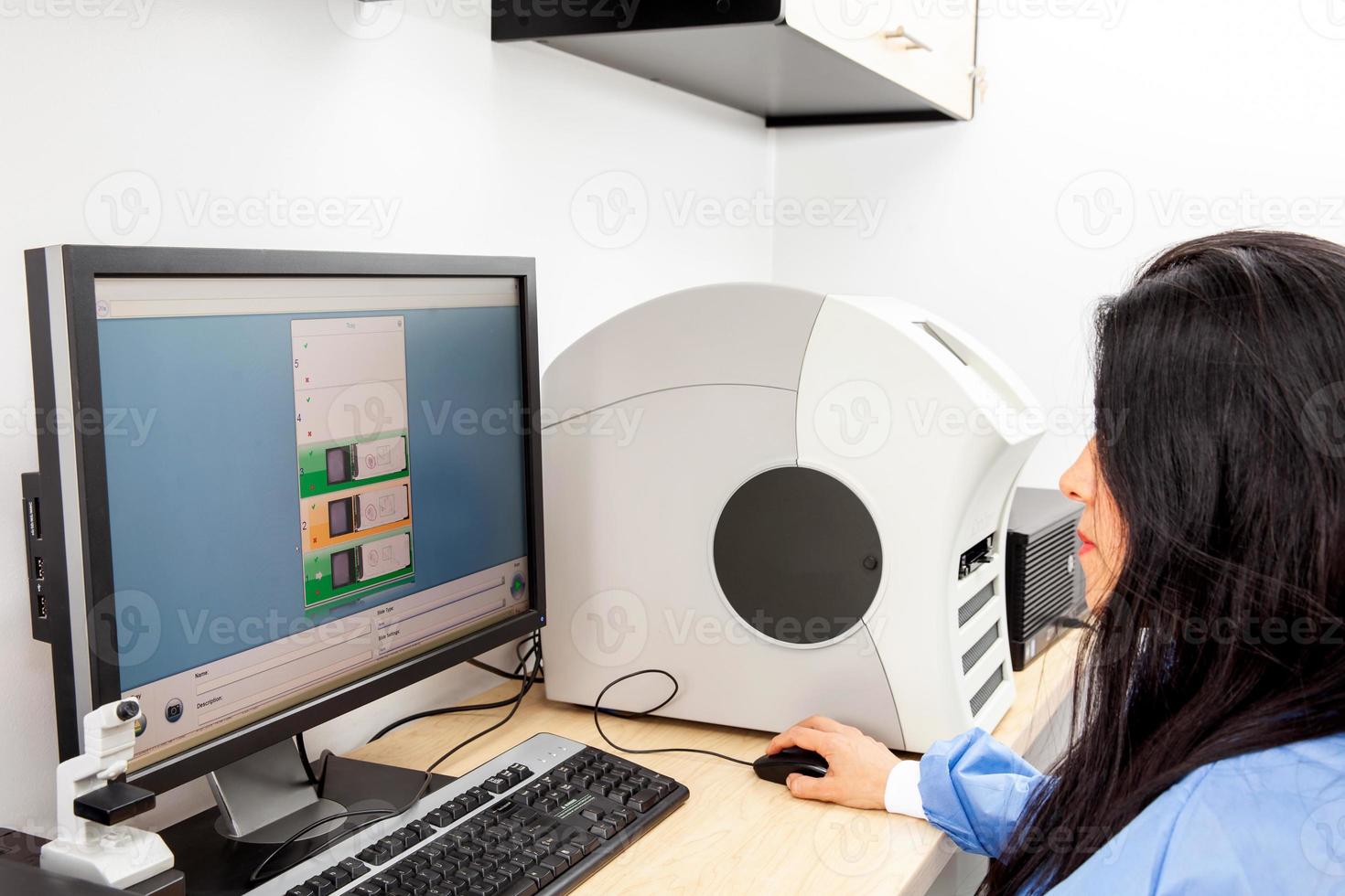 Young female scientist scanning microscope slides with tissue samples for pathology studies. Cancer diagnosis concept. Medical technology concept. photo