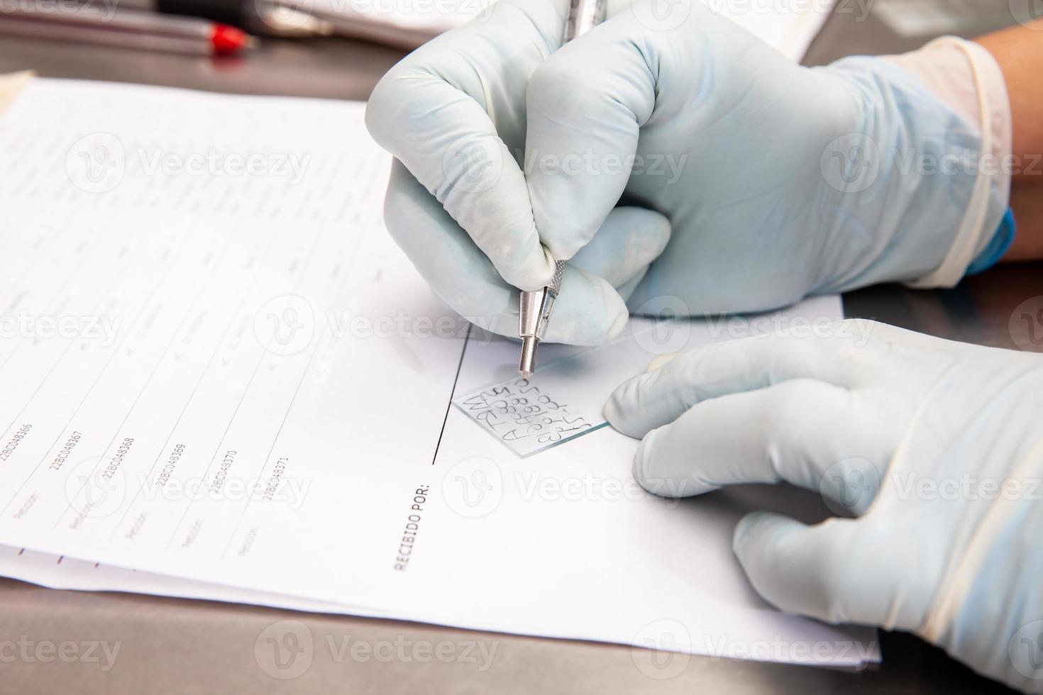 Laboratorian giving admission to pap smear samples in the laboratory for analysis. Scientist receiving patient samples for laboratory for analysis. Cervical cancer concept. Medical concept. photo