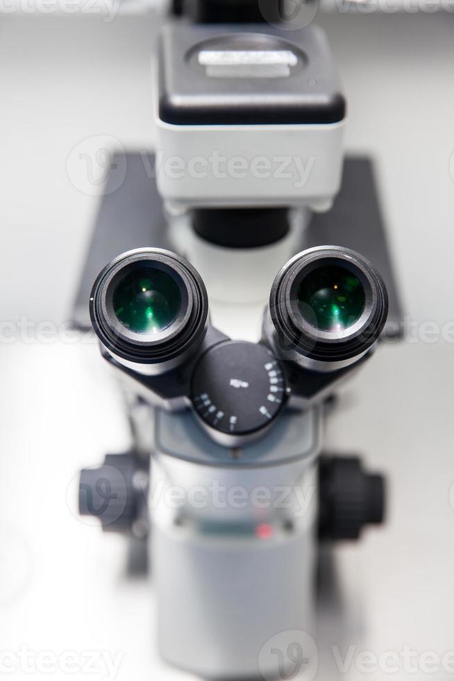 Close up of stereo microscope eyepieces in the laboratory photo