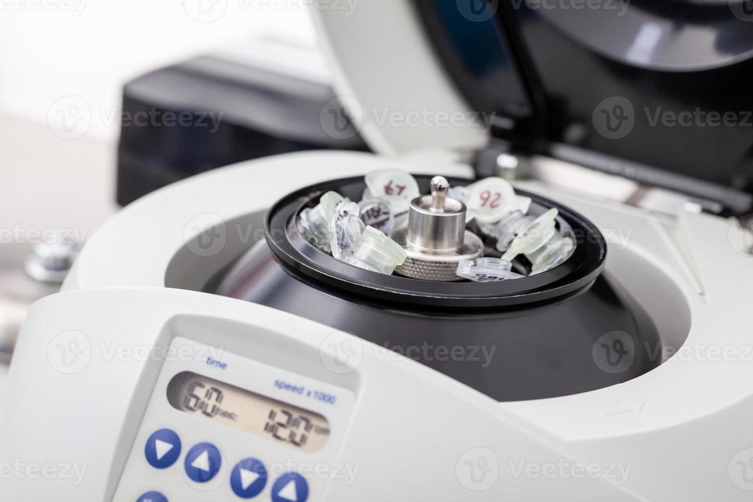 Table centrifuge filled with tubes. Spin column-based nucleic acid purification technique. photo