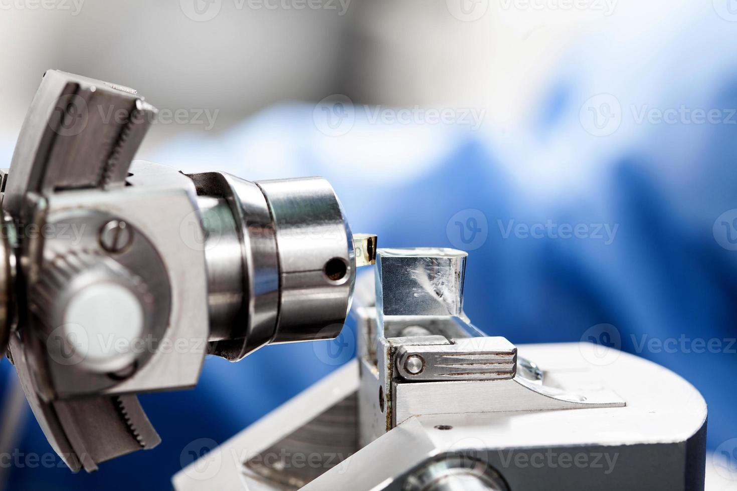 Closeup of an epoxy embedded tissue placed on the ultramicrotome to make sections for the electron microscope photo