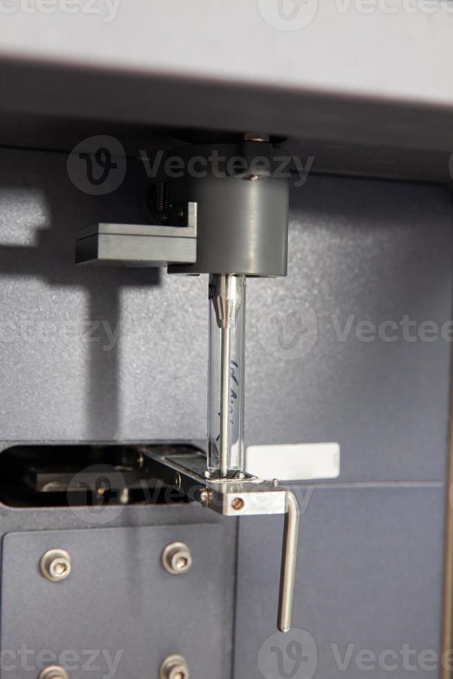 Test tube containing a patient sample loaded on the  flow cytometer ready for analysis. Flow cytometer photo