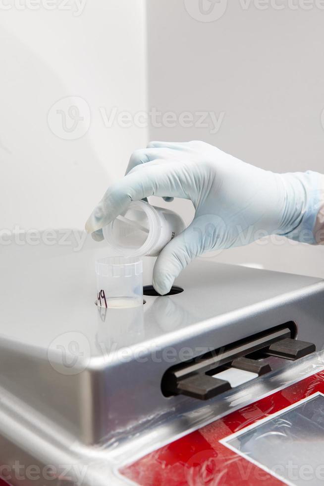 Scientist preparing microscope slides with liquid based cytology method for pap smear test. Cervical cancer concept. Medical concept. photo