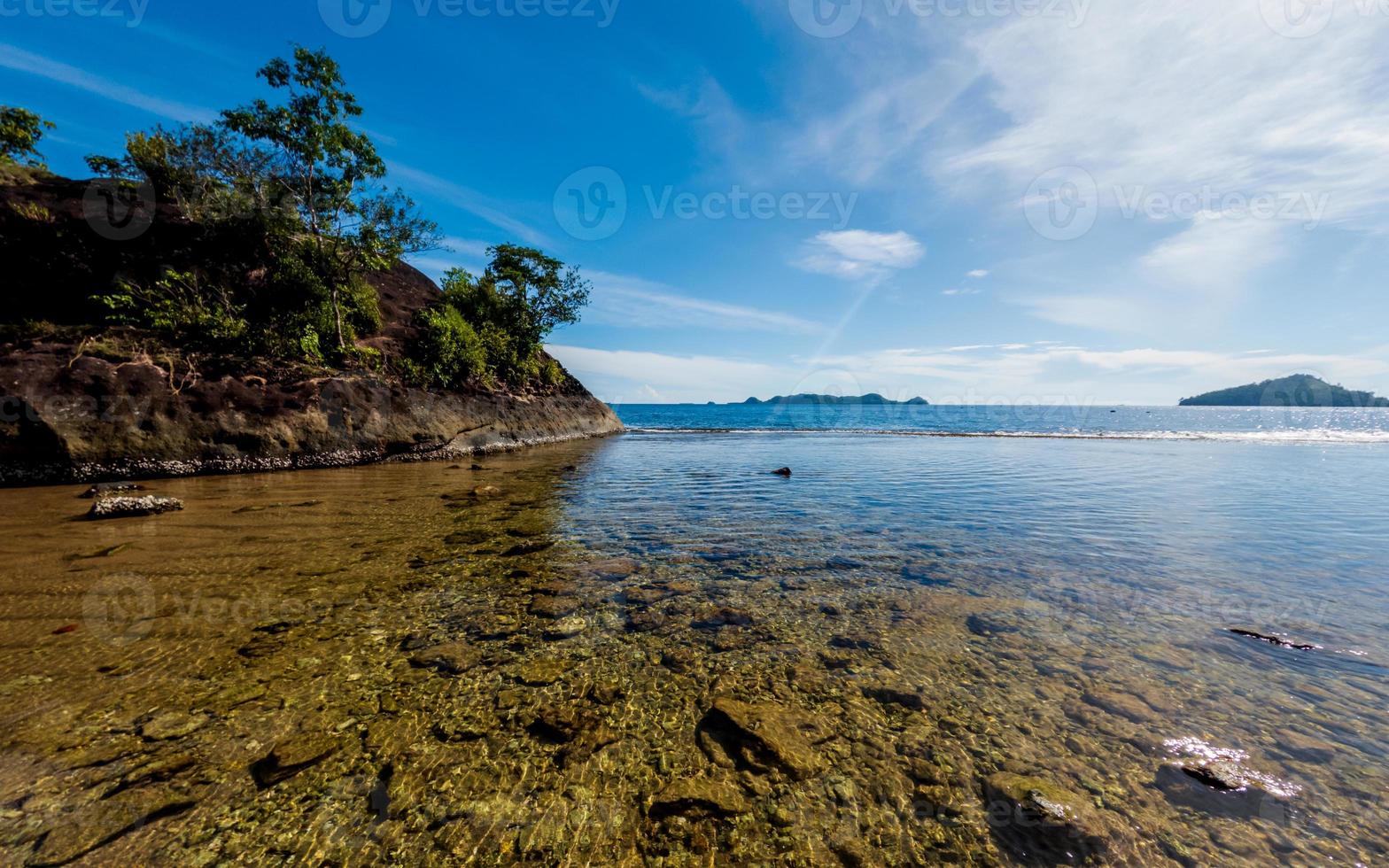 Tropical beach with rocks in West Sumatra coast, Indonesia photo