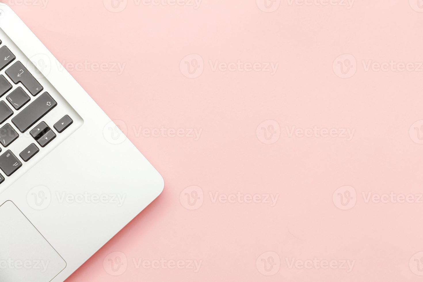 Keyboard laptop computer isolated on pink pastel desk background. Modern Information technology and sofware advances photo