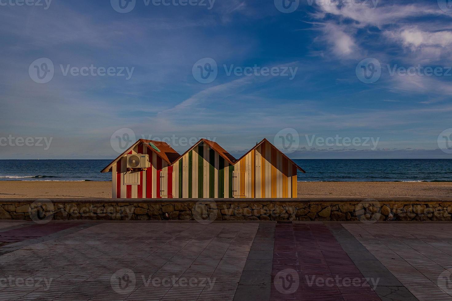 peaceful seaside landscape with three colorful wooden houses beach and vacation photo