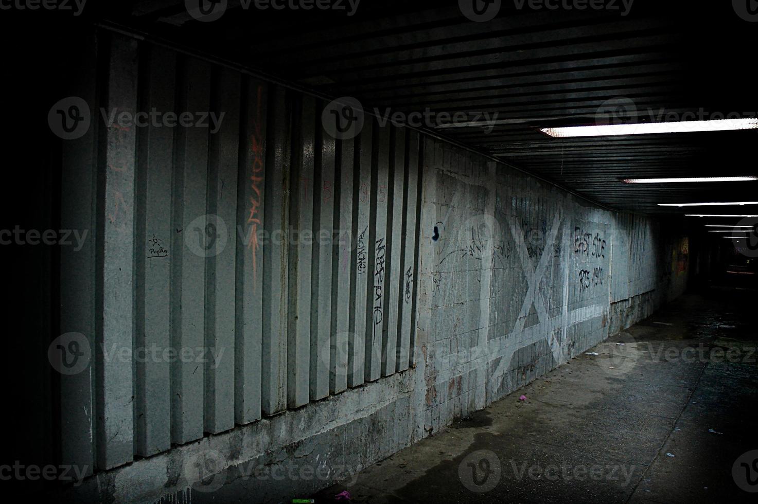 abandoned urban underground passage with graffiti on the wall photo