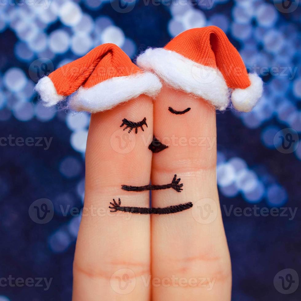 Couple kissing and hugging in the new year hats. photo