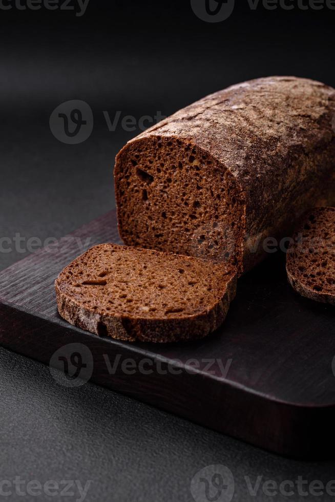 Loaf of fresh crispy brown bread with grains and seeds photo