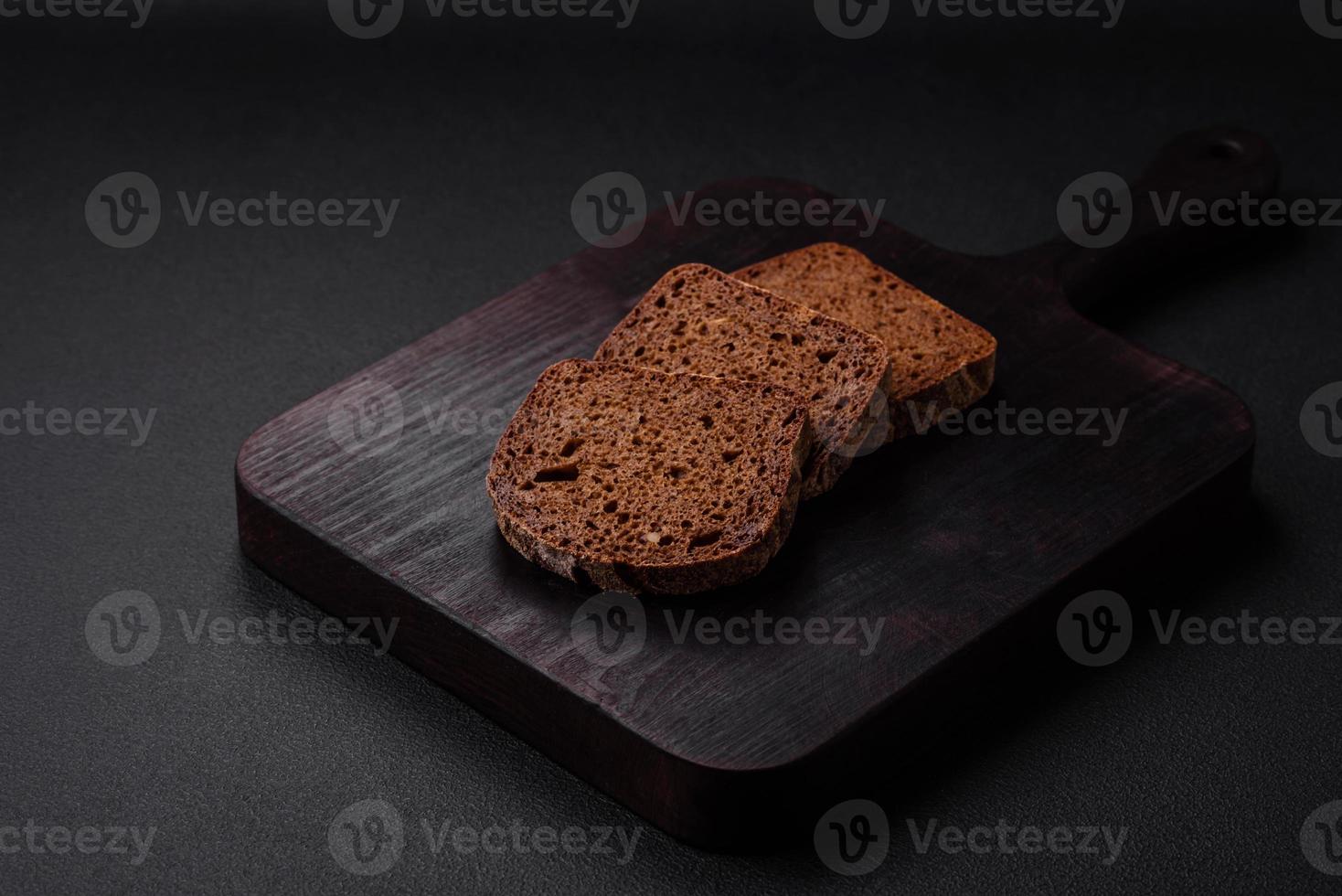 Loaf of fresh crispy brown bread with grains and seeds photo