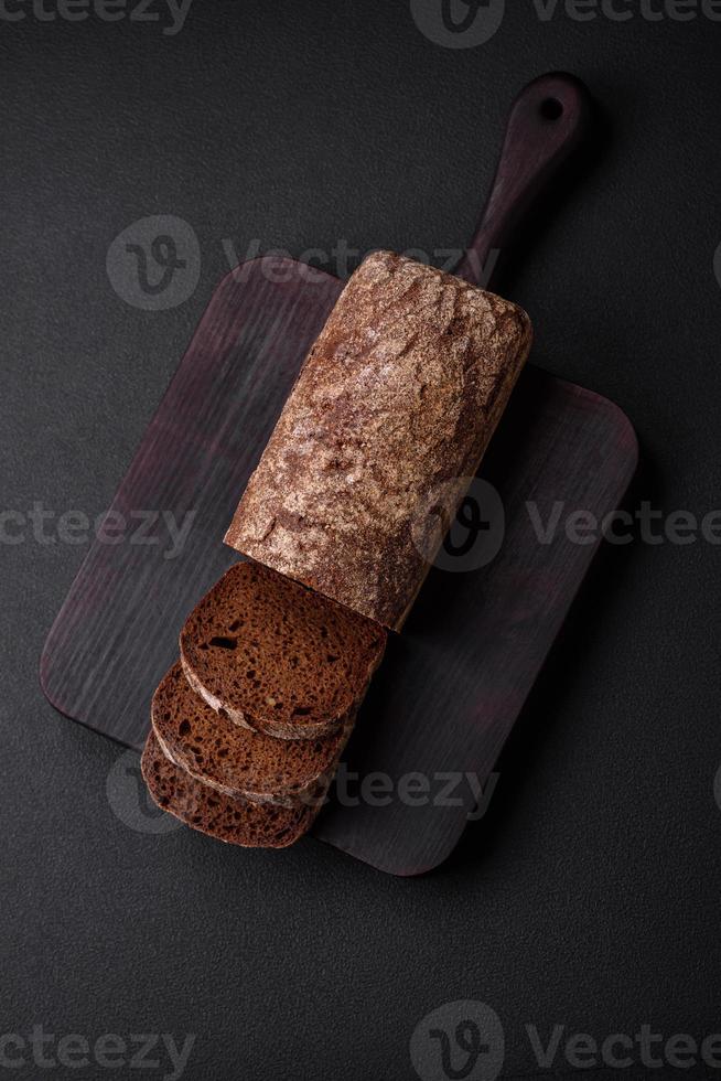 Loaf of fresh crispy brown bread with grains and seeds photo