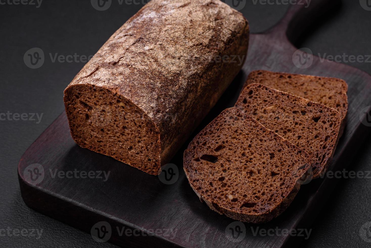 Loaf of fresh crispy brown bread with grains and seeds photo