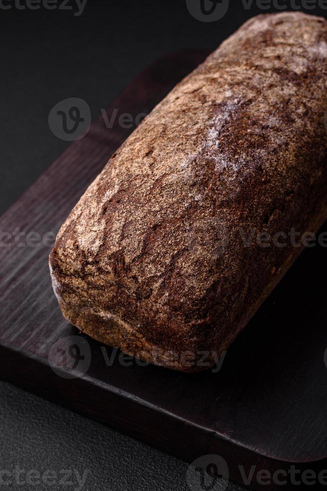 Loaf of fresh crispy brown bread with grains and seeds photo