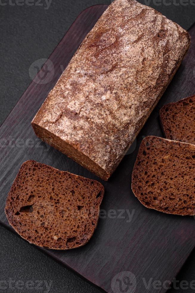 Loaf of fresh crispy brown bread with grains and seeds photo