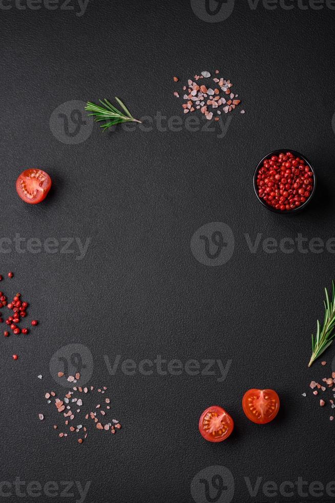 Ingredients for cooking a delicious vegetarian dish cherry tomatoes, rosemary, salt photo