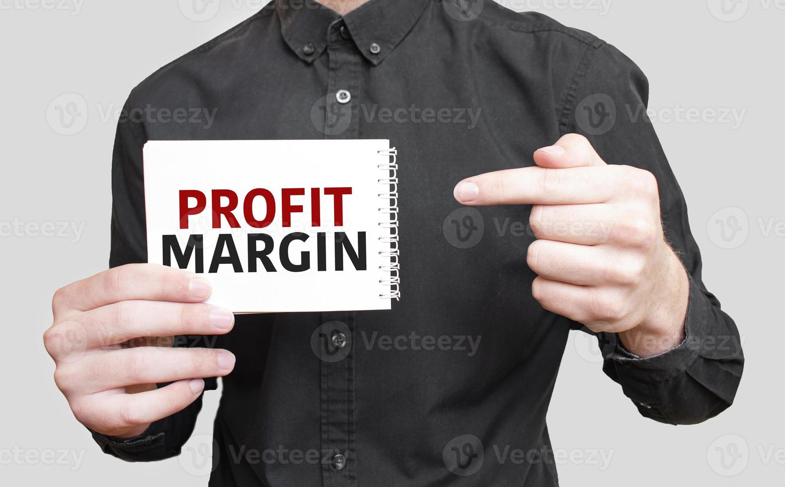 Businessman holding a card with text profit margin ,business concept photo