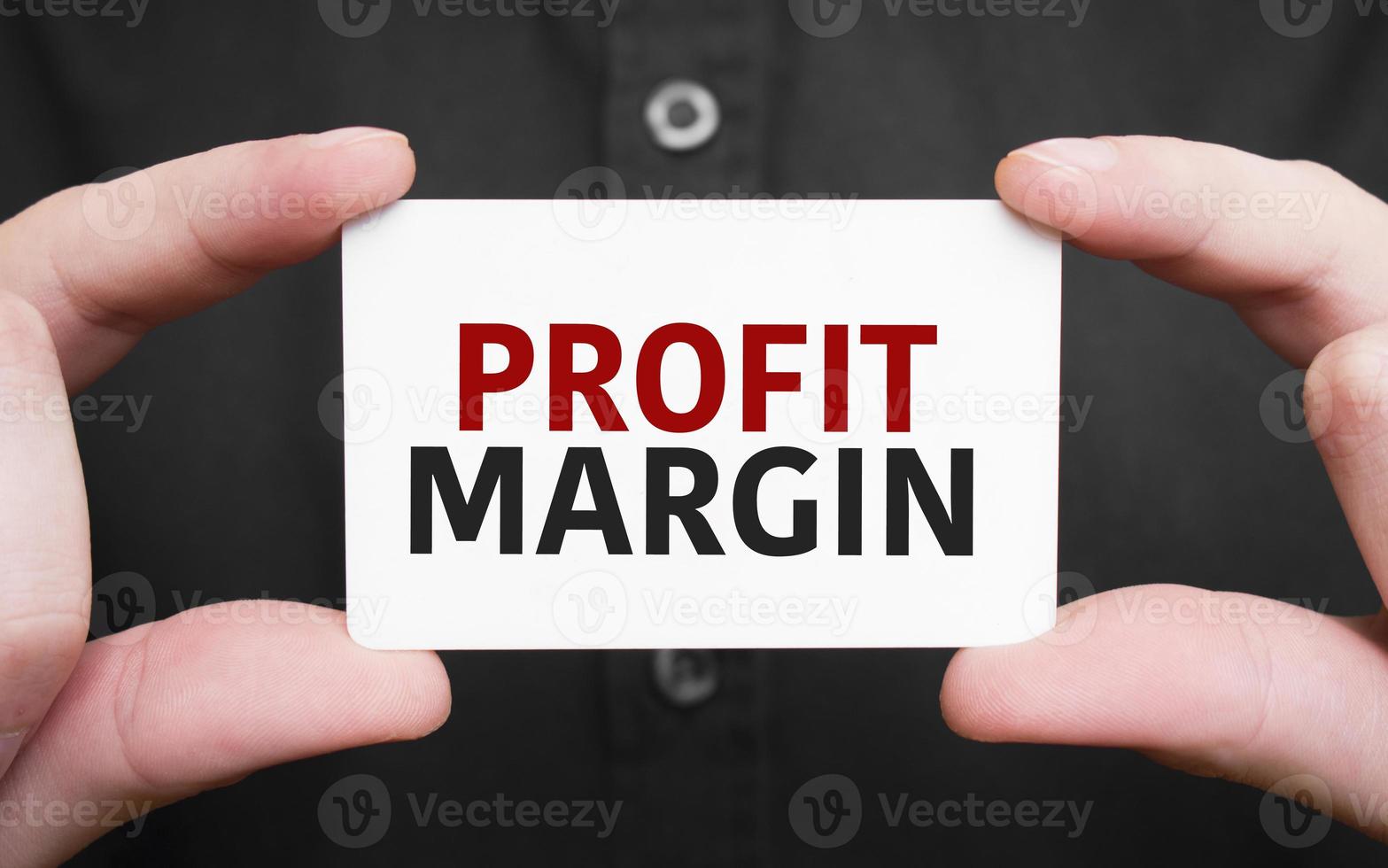 Businessman holding a card with text profit margin ,business concept photo