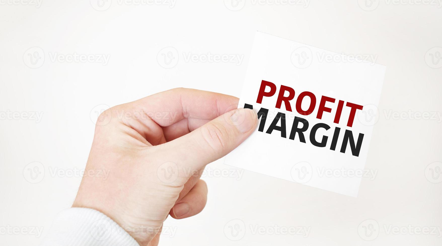 Businessman holding a card with text profit margin ,business concept photo