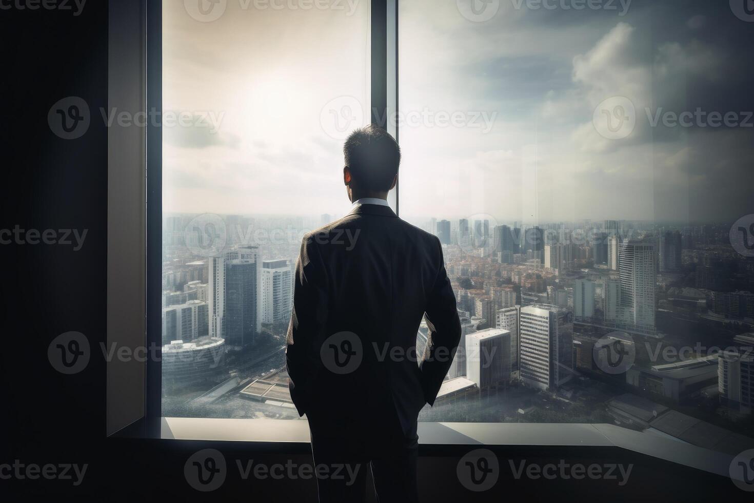 A businessman seen from behind is looking out of an office window in the big city created with technology. photo