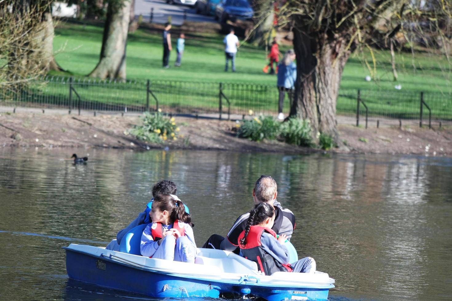 Beautiful View of People Boating a Paddle Boat at a Lake of Local Public Park of Luton England UK. Image Was Captured on 03-April-2023 photo