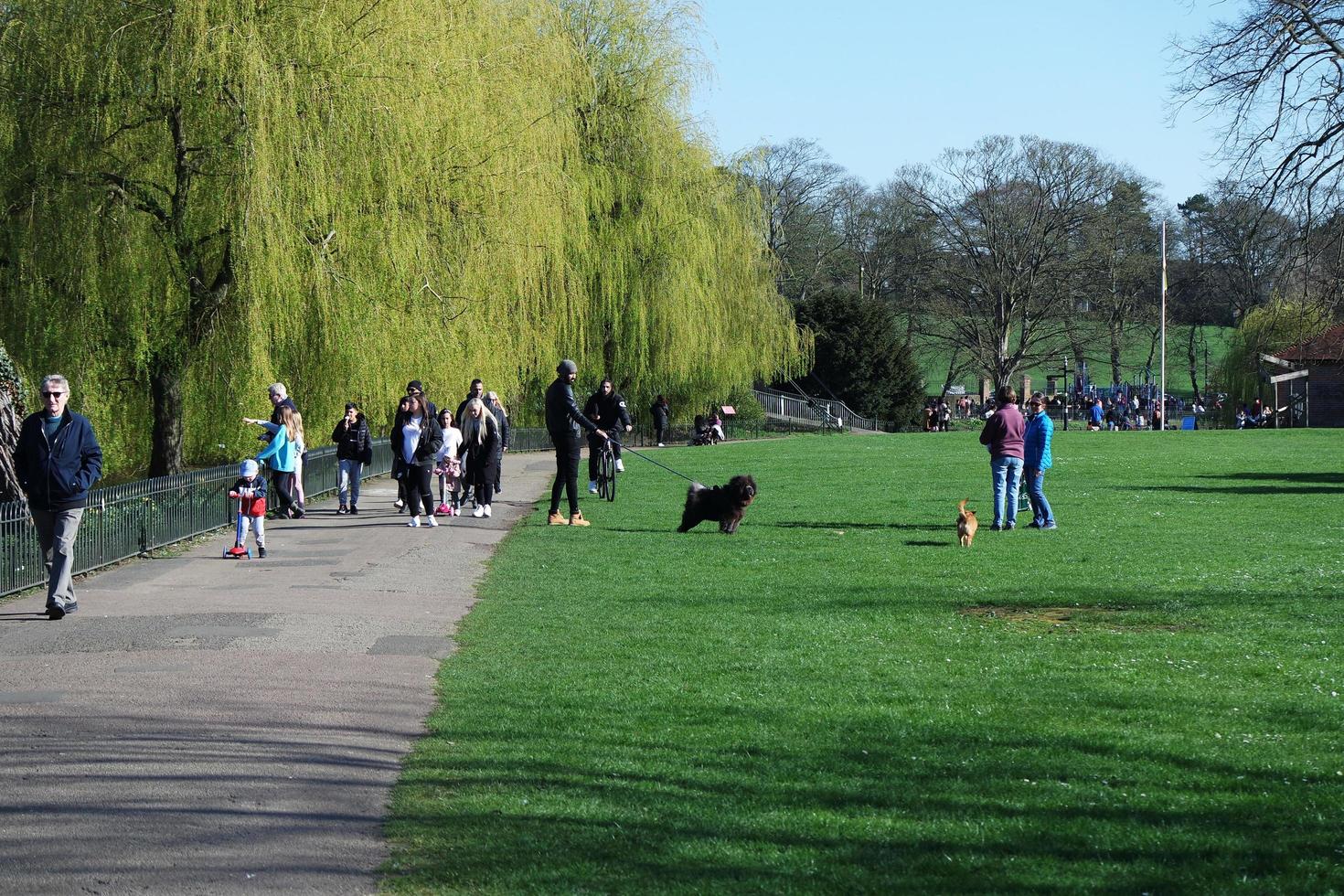 Gorgeous View of Wardown Public Park and People are Enjoying the Beautiful and Bright Sunny Day. They are Spending Day with Their Families and Having Fun. Image Was Captured at Luton on 03-April-2023 photo