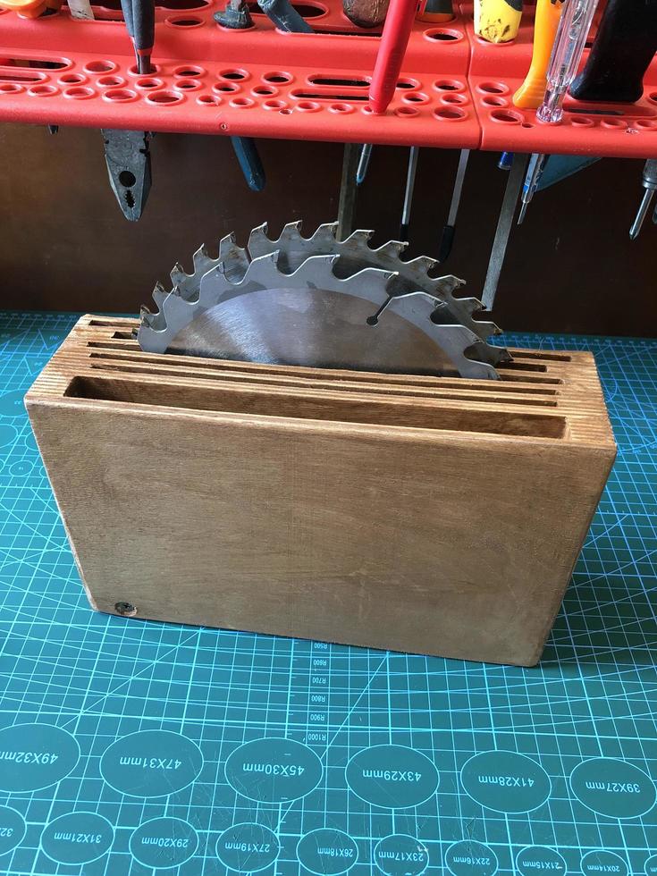 steel circular saws in a wooden box on a table in a workshop photo