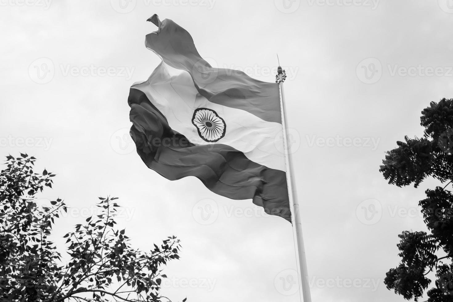 India flag flying high at Connaught Place with pride in blue sky, India flag fluttering, Indian Flag on Independence Day and Republic Day of India, tilt up shot, Waving Indian flag, Har Ghar Tiranga photo