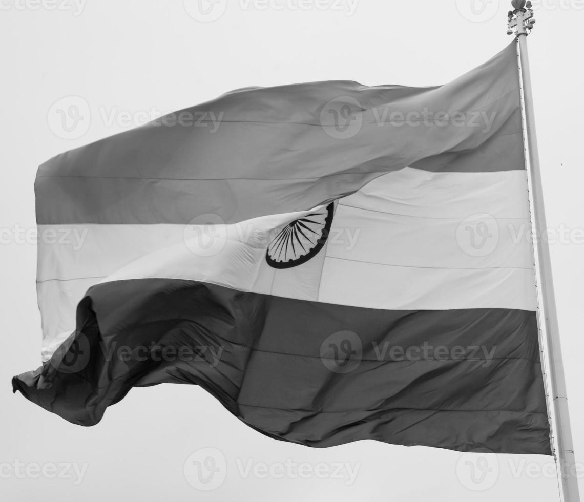 India flag flying high at Connaught Place with pride in blue sky, India flag fluttering, Indian Flag on Independence Day and Republic Day of India, tilt up shot, Waving Indian flag, Har Ghar Tiranga photo