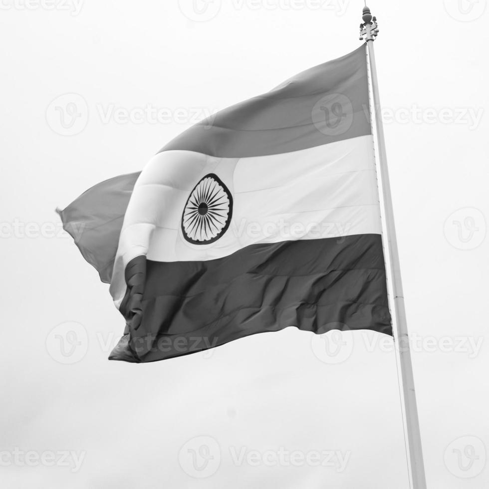 India flag flying high at Connaught Place with pride in blue sky, India flag fluttering, Indian Flag on Independence Day and Republic Day of India, tilt up shot, Waving Indian flag, Har Ghar Tiranga photo