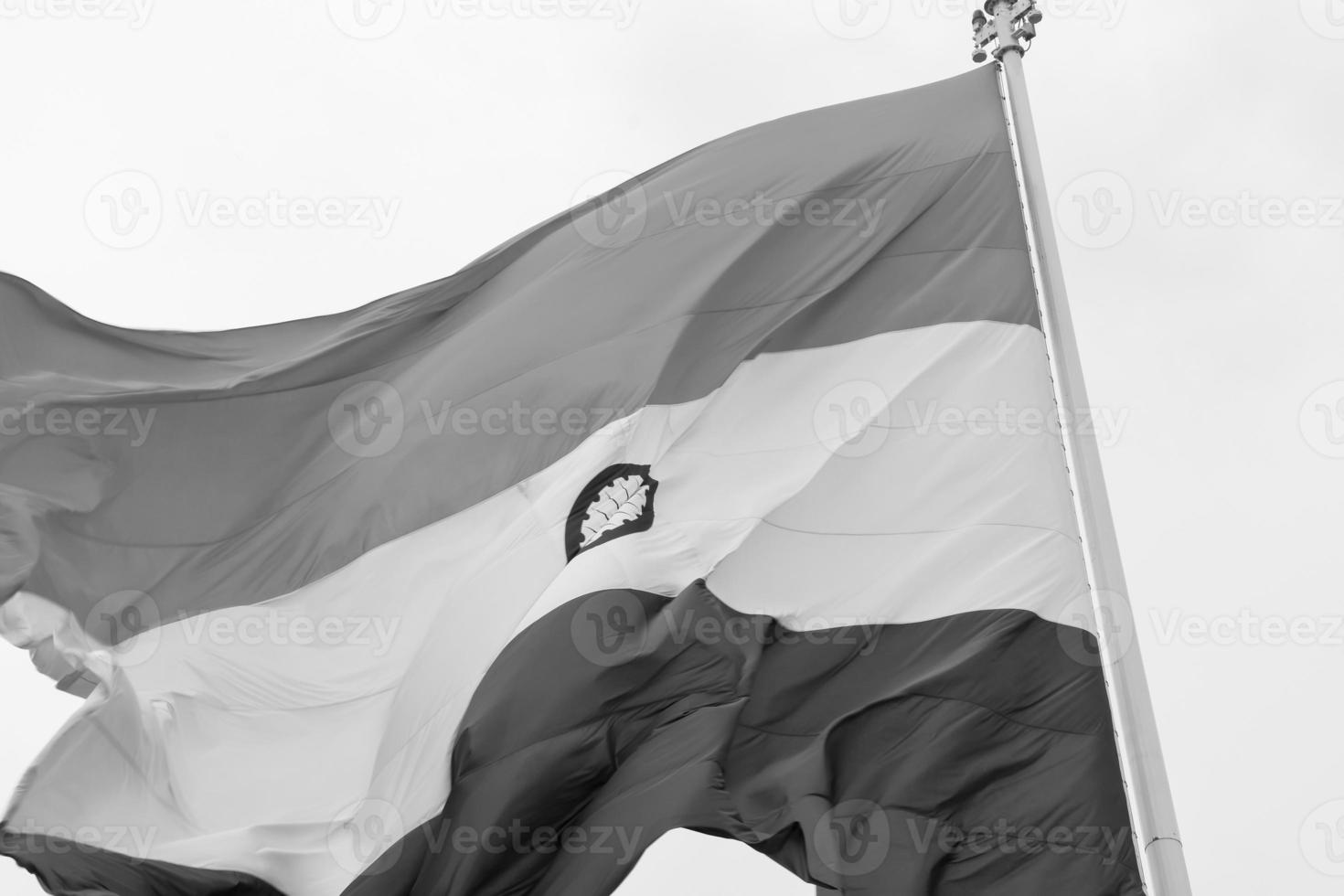 India flag flying high at Connaught Place with pride in blue sky, India flag fluttering, Indian Flag on Independence Day and Republic Day of India, tilt up shot, Waving Indian flag, Har Ghar Tiranga photo