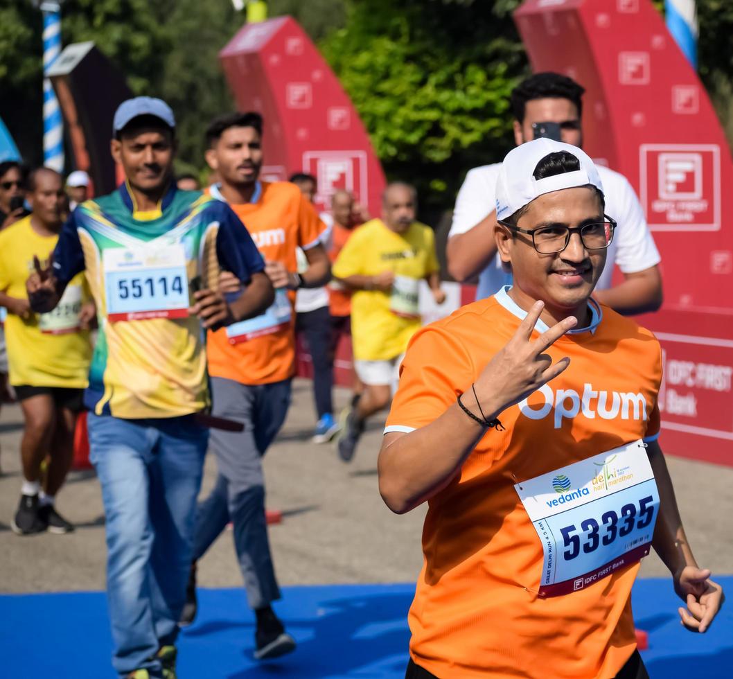 New Delhi, India - March 16 2023 - Vedanta Delhi Half Marathon race after covid in which marathon participants about to cross the finish line, Delhi Half Marathon 2022 photo