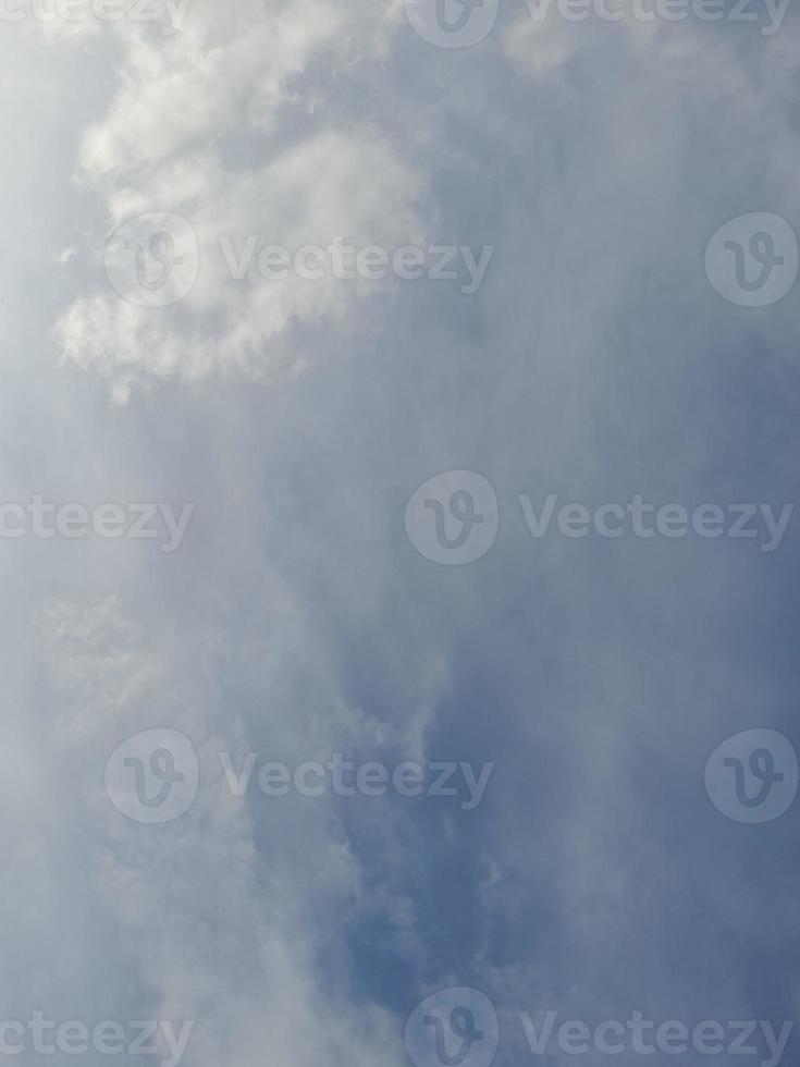 Beautiful white clouds on deep blue sky background. Large bright soft fluffy clouds are cover the entire blue sky. photo