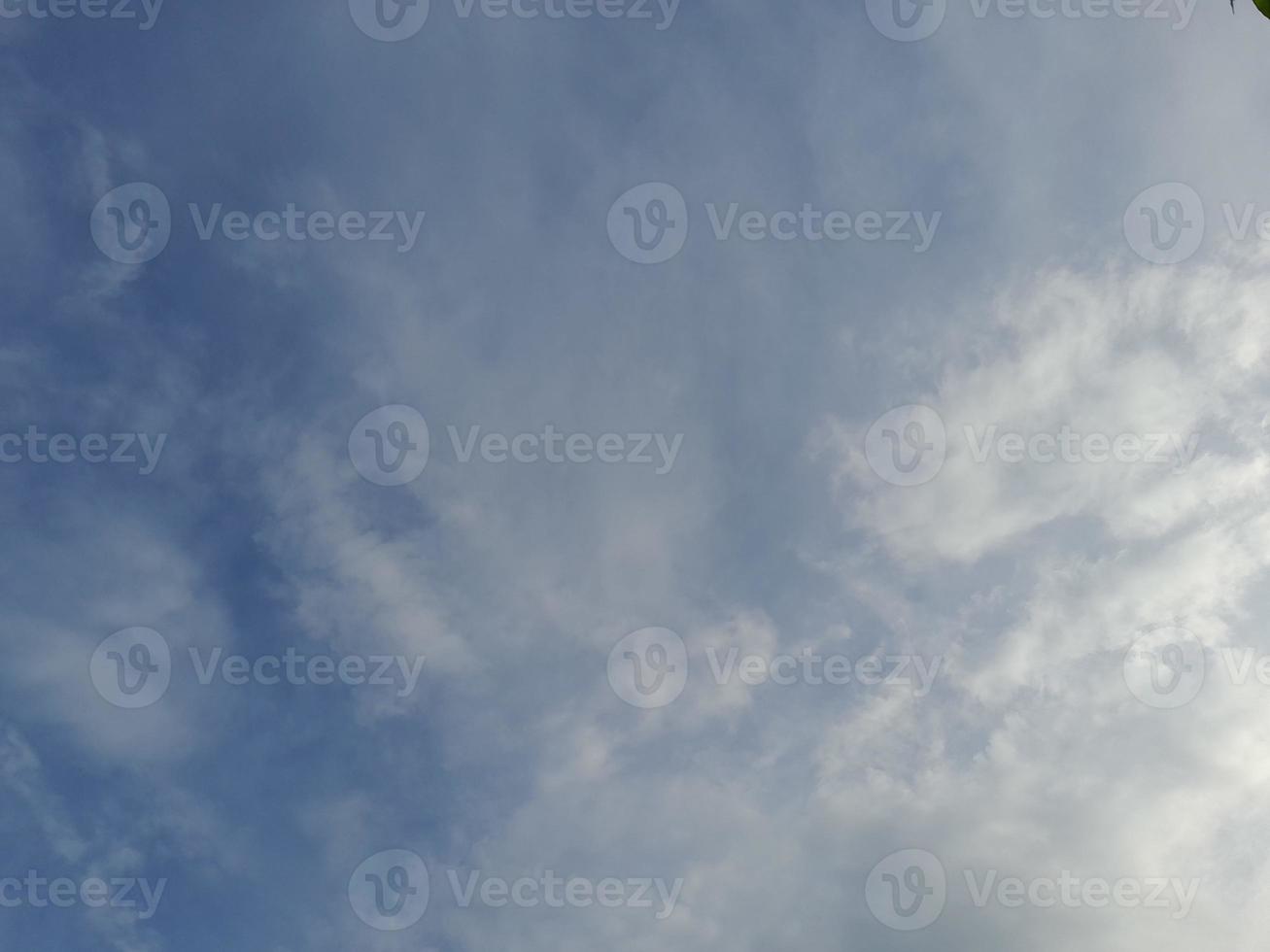 Beautiful white clouds on deep blue sky background. Large bright soft fluffy clouds are cover the entire blue sky. photo